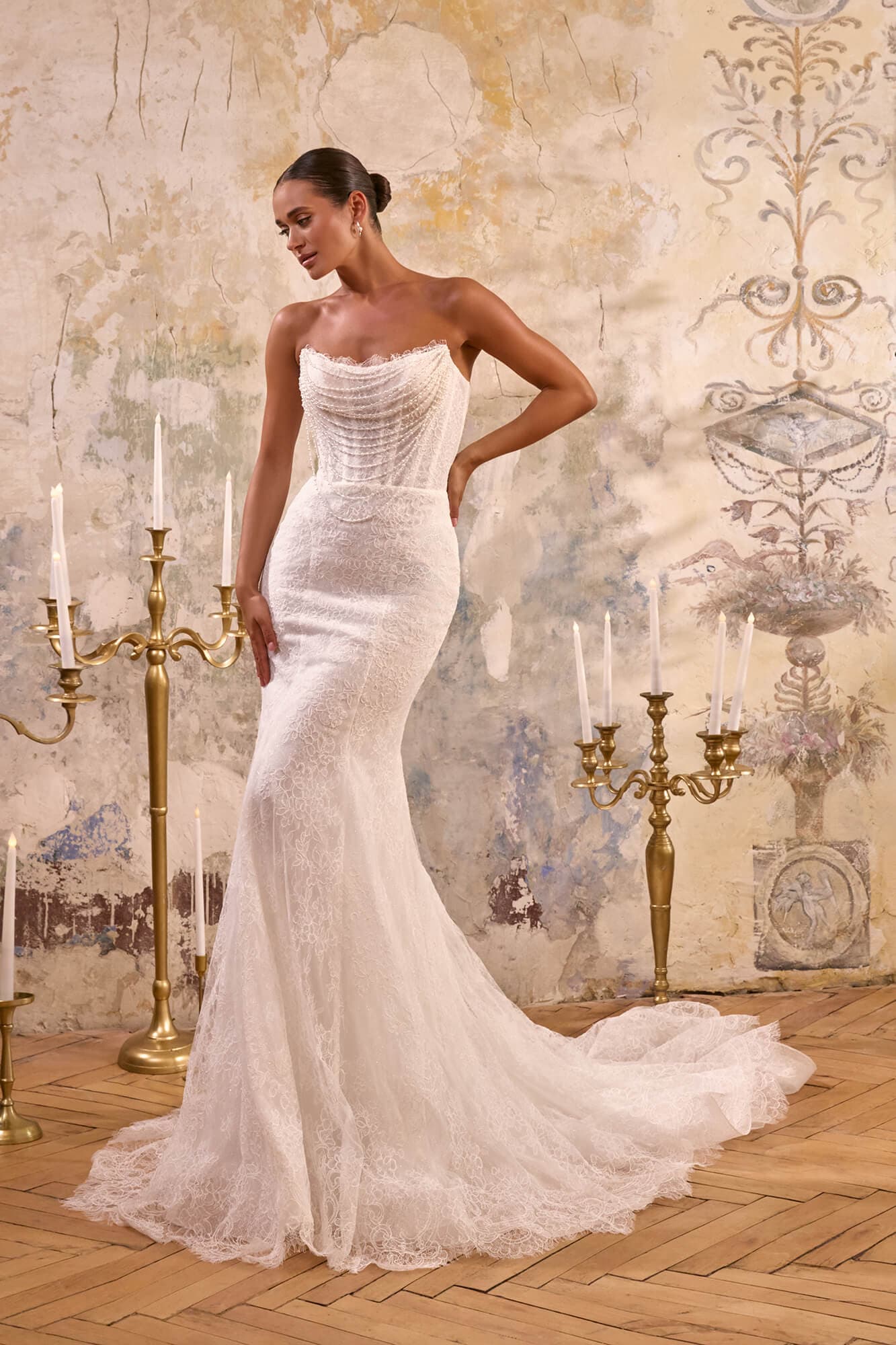 Elegant strapless lace mermaid wedding dress Adele with draped corset, fitted silhouette and chapel train.