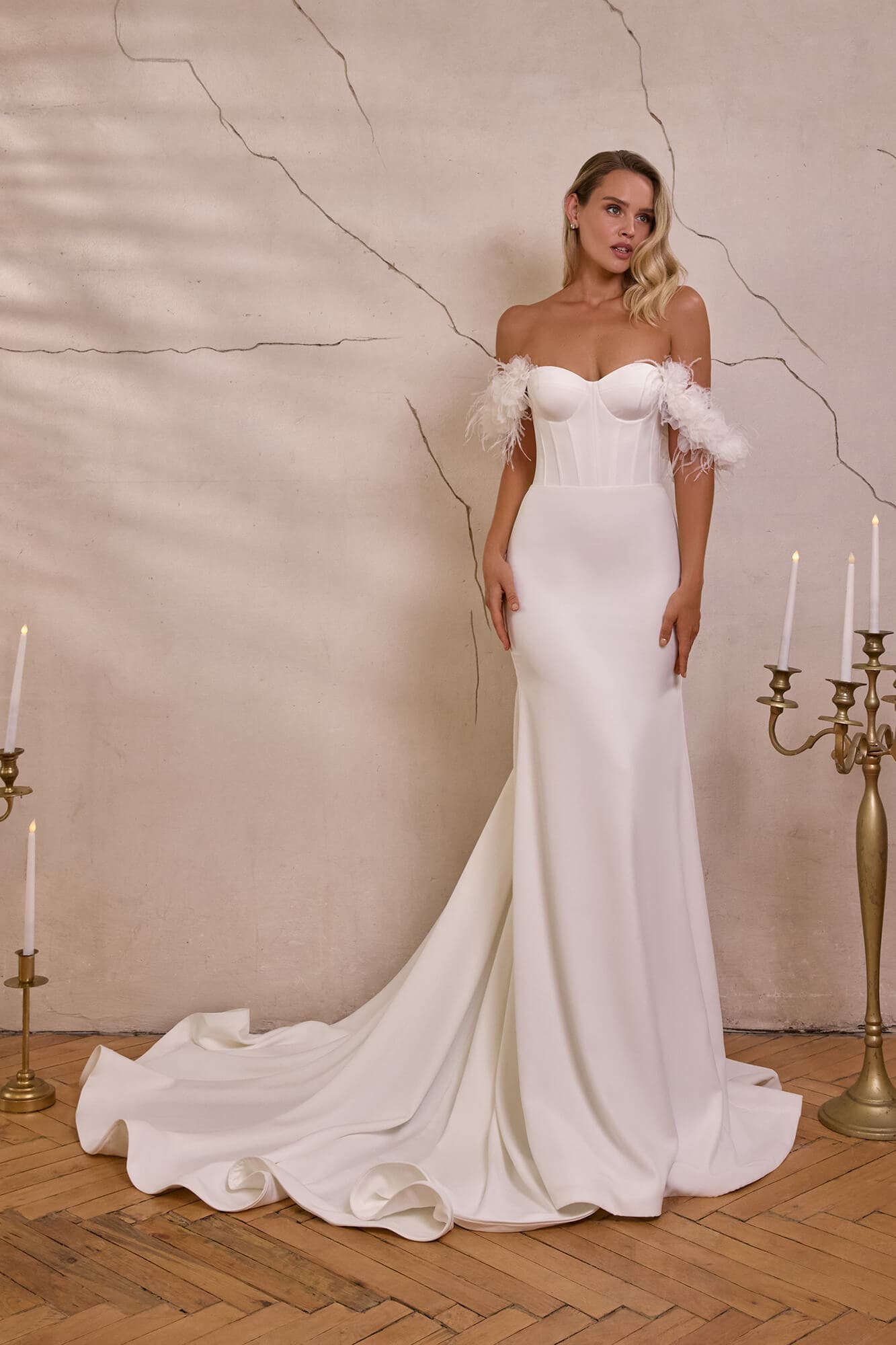 Romantic A-line wedding dress Georgia with illusion corset, floral lace appliqués, flowing tulle skirt and elegant chapel train.