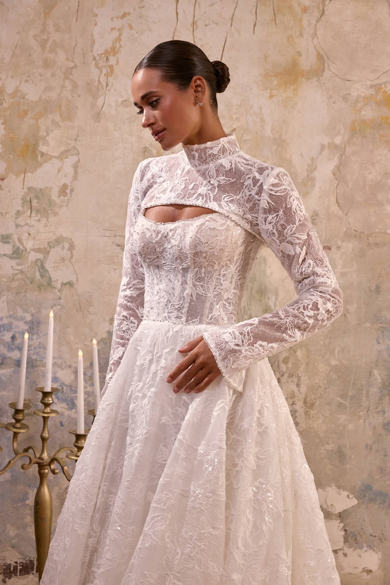 Elegant A-line wedding dress Gwen with illusion corset, floral lace appliqués, flowing tulle skirt and romantic chapel train.