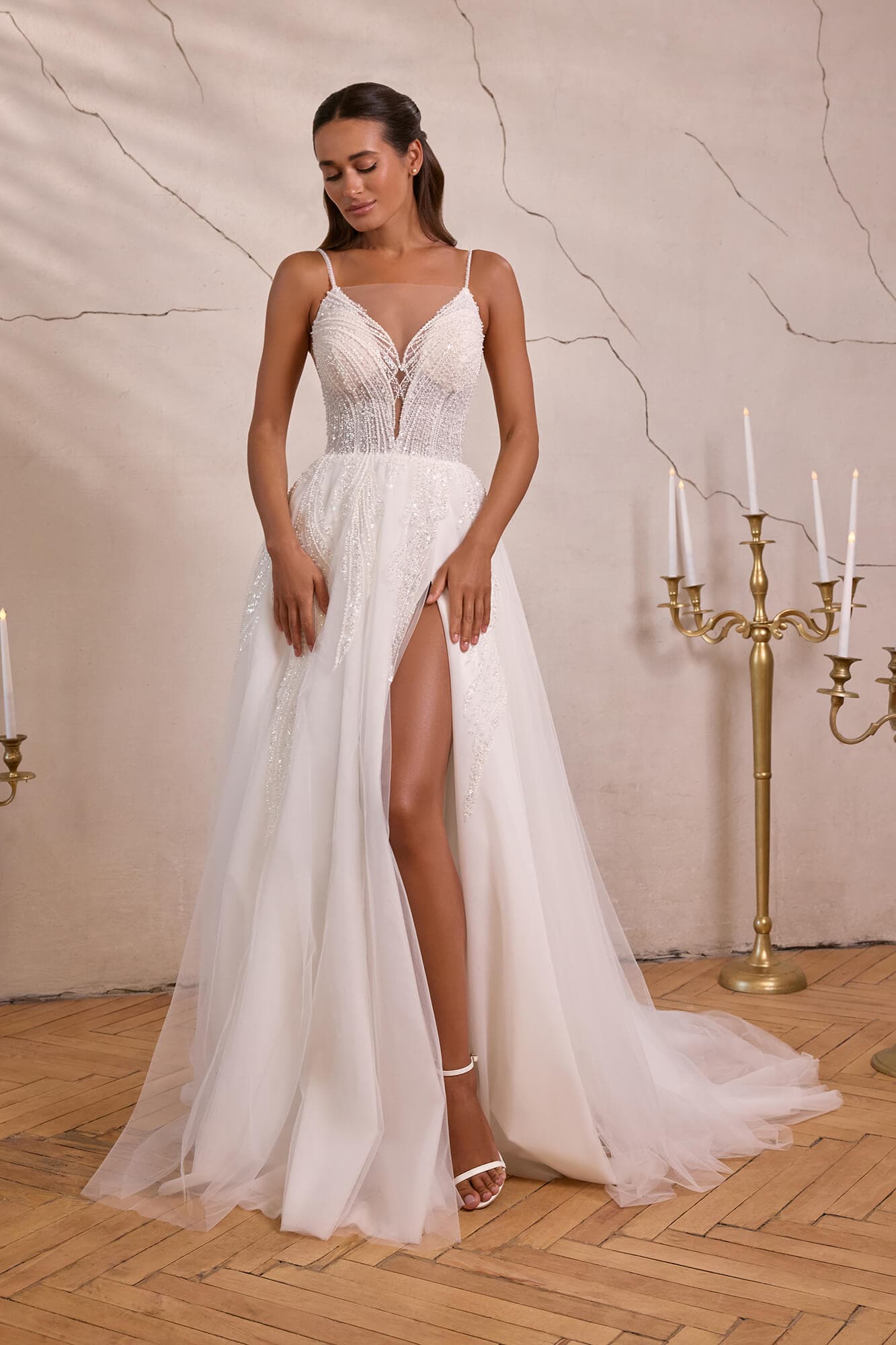 Elegant A-line wedding dress Eline featuring an illusion corset, floral lace embroidery, flowing tulle skirt and graceful chapel train.