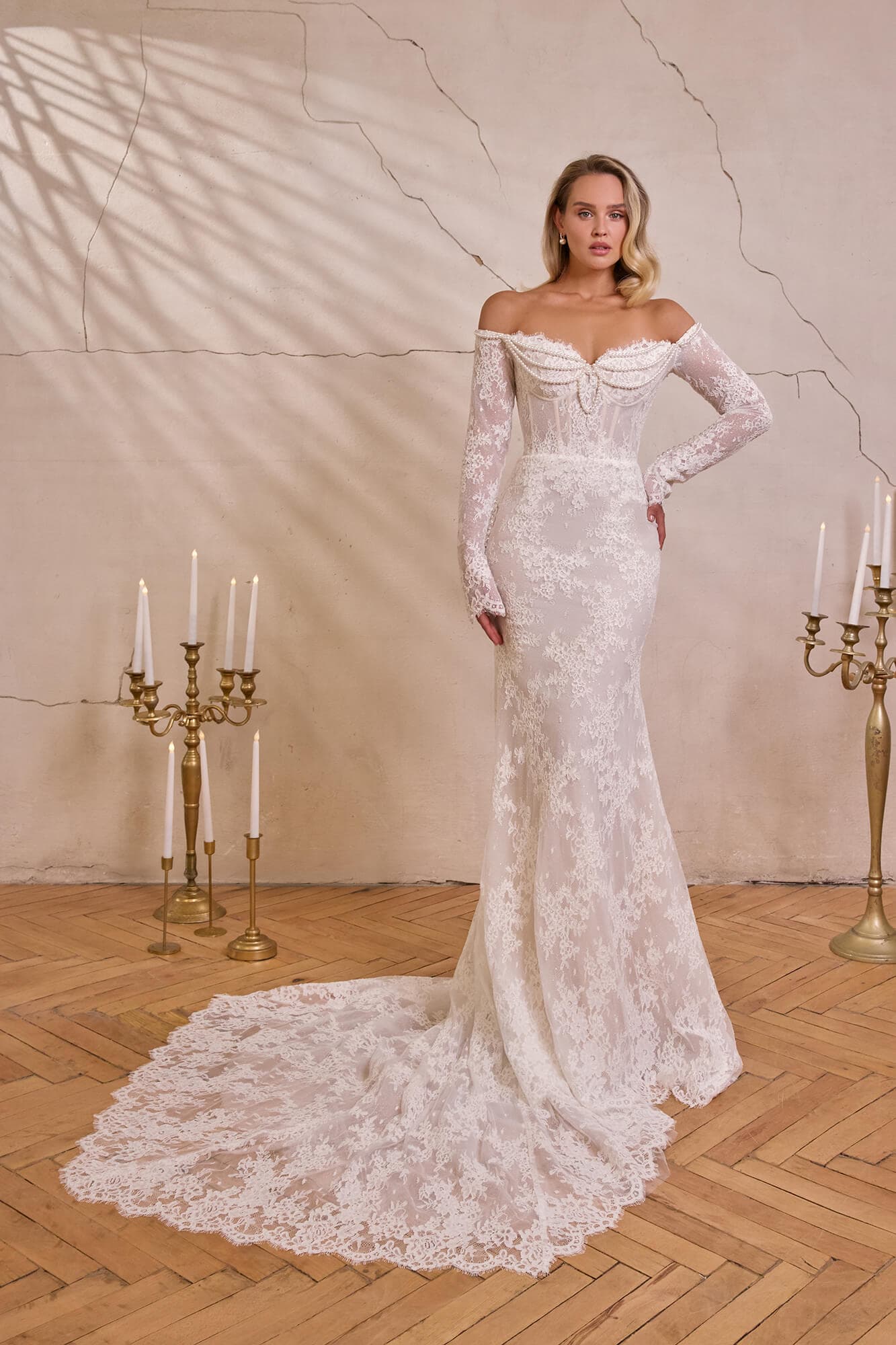 Elegant A-line wedding dress Harper featuring an illusion corset, floral lace appliqués, flowing tulle skirt and graceful chapel train.
