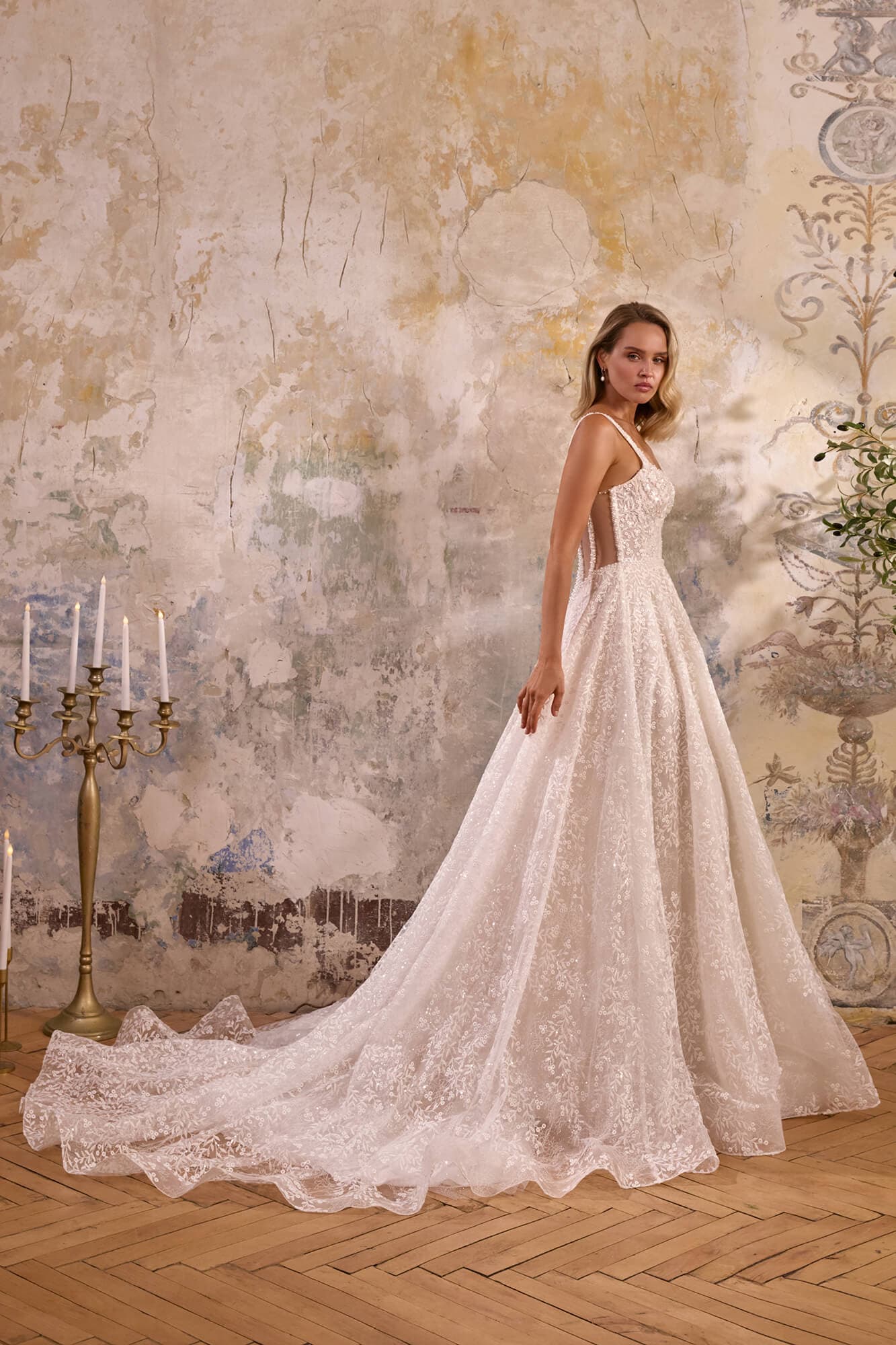 Luxury A-line wedding dress Jacline featuring an illusion corset, delicate floral lace, flowing tulle skirt and elegant chapel train.